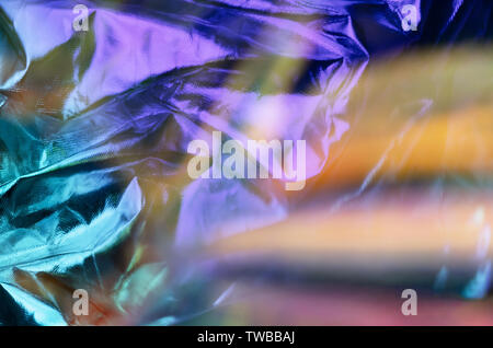 Modern beautiful holographic background of blurred crumpled foil. Trendy 80's style. Wallpaper design. Stock Photo