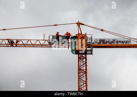 Workmen Working On A Crane, Whangarei, North Island, New Zealand Stock Photo