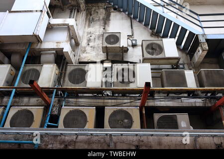 Group of condensing units of air conditioners installed on canopy behind the building, behind the scene concept Stock Photo