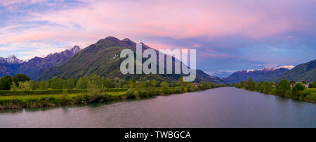 Aerial panoramic of sunset over river Adda and Rhaetian Alps, Sondrio province, Lower Valtellina, Lombardy, Italy Stock Photo