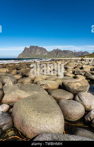 Utakleiv Beach, Lofoten Islands,Norway on a bright spring day. The beach has many large rounded boulders Stock Photo