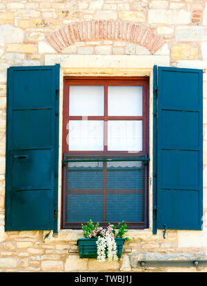 Beautiful vintage window with open blue shutters Stock Photo