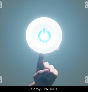 Finger switching on Power button on grey background, copy space Stock Photo