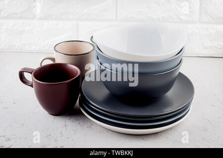 Set of clean Ceramic crockery tableware on gray concrete background, color bowls, plate, cup, dishes.  tableware set concept Stock Photo