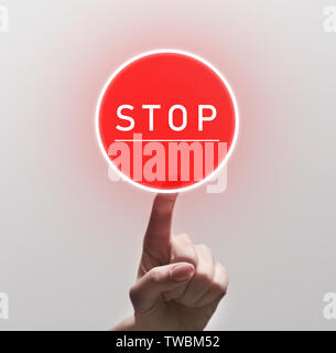 Woman Finger Pushing red round Stop sign, copy space Stock Photo