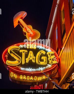 Restaurant bar and concert venue The Stage on Broadway neon sign lit up at night in Broadway Nashville Tennessee USA. Stock Photo