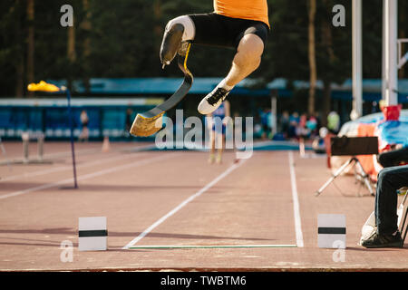 athlete amputee on prosthetic leg long jump competition at athletics Stock Photo