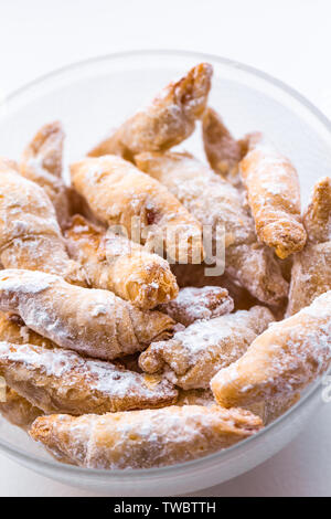 Cornulețe. A traditional Romania dessert that is a small croissant stuffed with jam or Turkish delight sprinkled with icing sugar Stock Photo