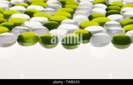 artificial round stones of green and white color. imitation pebbles Stock Photo