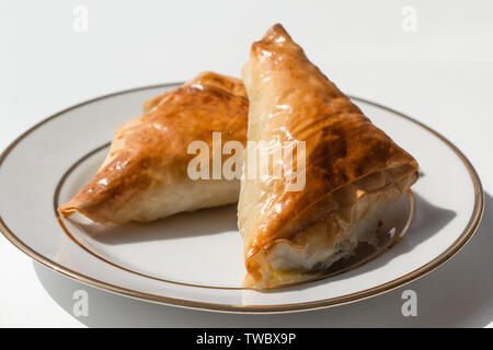 Spanakopita in the shape of a triangle on a plate Stock Photo