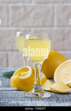 Italian traditional liqueur limoncello with lemon Stock Photo