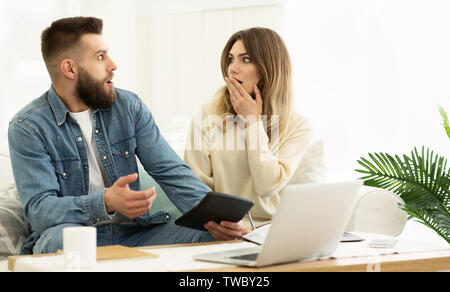 Financial Problems. Young Couple Managing Family Budget, Calculating Expenses Stock Photo