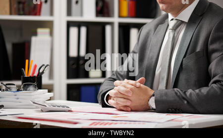 Businessman working and calculating, reads and writes reports. Office employee, table closeup. Business financial accounting concept. Stock Photo