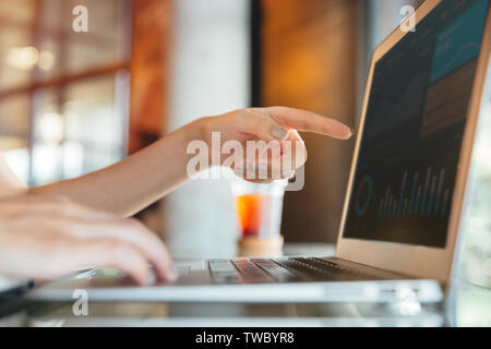 Isolated mockup image of laptop and female hand pointing finger to laptop screen have a screen chart. Freelancer or student working on new project. Bu Stock Photo