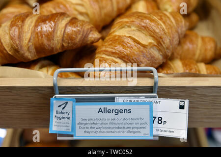 Allergy advisory notice on fresh bakery goods in a supermarket UK Stock Photo