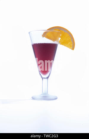 Isolated cup of homemade vermouth decorated with an orange slice Stock Photo