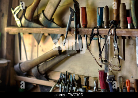 Old tools for carpentry work, hanging on rack Stock Photo