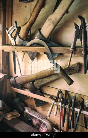 Old tools for carpentry work, hanging on rack Stock Photo