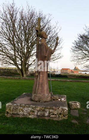 The statue of Saint. Aidan was erected in his honour on Lindisfarne Priory on Holy Island (Lindisfarne) in Northumberland, Britain.  Holy Island is Stock Photo