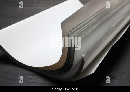 Rolled Up Book on Wooden Background Stock Photo