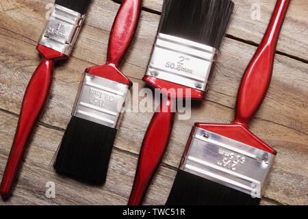 Paint Brushes on Rustic Wooden Background Stock Photo