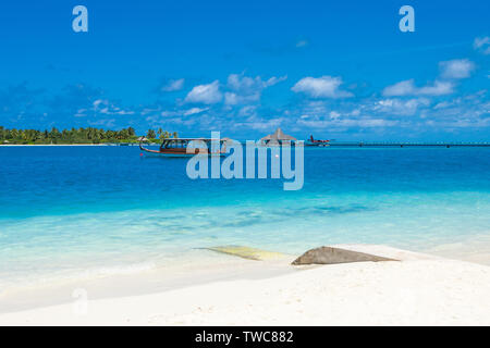 Beautiful sandy beach and traditional dhoni boat in Indian ocean, Maldives island Stock Photo