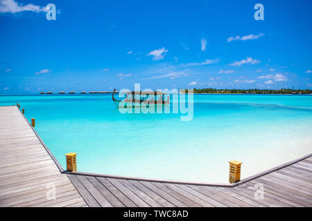 Rangali, Maldives island - 14 July 2017: Traditional wooden boat dhoni in the crystal water of the Indian Ocean, Maldives island, 14 July 2017 Stock Photo