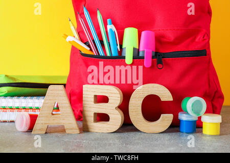 School supplies on grey table against color background, space for text Stock Photo