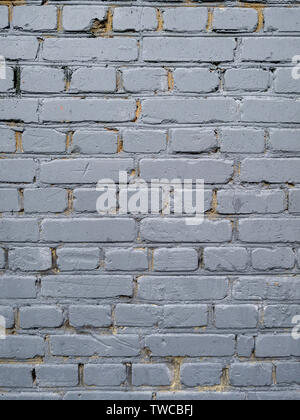 Old brick wall painted with gray oil paint Stock Photo