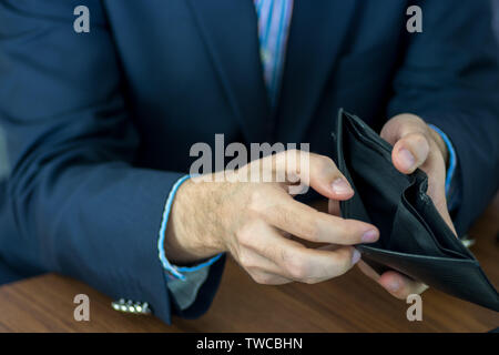 Men hands with suit showing an empty wallet Stock Photo