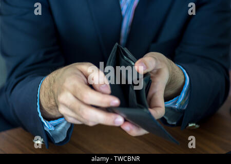 Men hands with suit showing an empty wallet Stock Photo