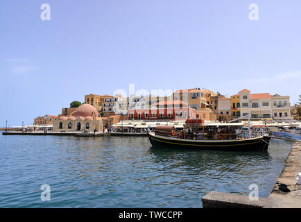 Excursion boat cruising Venetian harbour and mediterranean sea of Chania, Crete, Greece Stock Photo