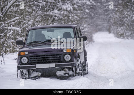 Russian off-road car Lada Niva on a snowy road Stock Photo