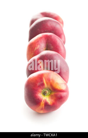 Ripe flat nectarines isolated on white background. Stock Photo