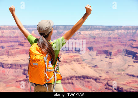 Success winner person happy hiker in Grand Canyon. Woman cheering with arms raised up in winning gesture enjoying the beautiful landscape. Hiking girl wearing backpack during summer in, Arizona, USA. Stock Photo