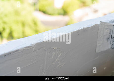 Texture of white plaster. Covering the concrete wall of the house. Rough surface. Repair and construction. Stock Photo