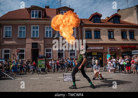 Fire eater - street performer on UFO - Street festival of curiosities, an international meeting of street performers, Szamotuly, Poland Stock Photo