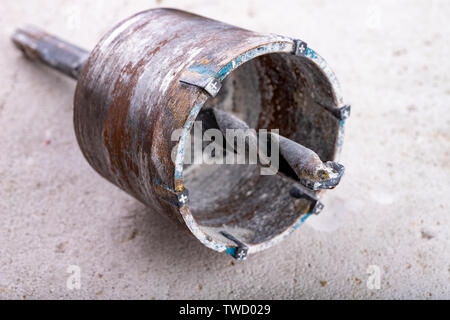 Drill for drilling large holes in the wall. Device for making holes for electrical sockets. Place - workshop. Stock Photo