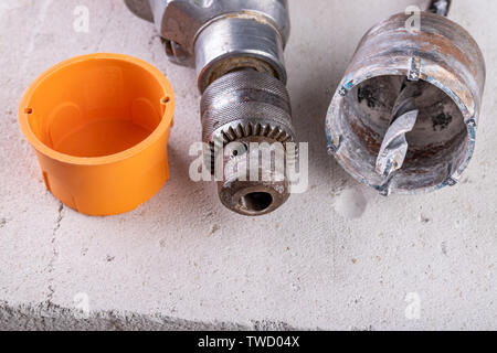 Drill for drilling large holes in the wall. Device for making holes for electrical sockets. Place - workshop. Stock Photo