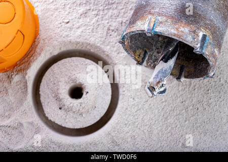 Drill for drilling large holes in the wall. Device for making holes for electrical sockets. Place - workshop. Stock Photo