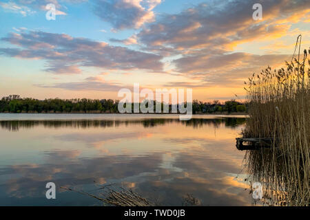 Summer landscape of sky and forest reflecting on mirror lake surface. outdoor summertime. Stock Photo