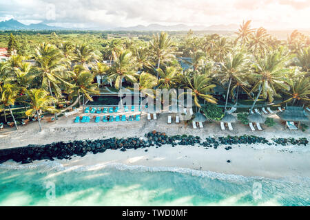 Aerial drone view at luxury resorts and coastline at Belle Mare beach on island Mauritius. Toned image. Stock Photo