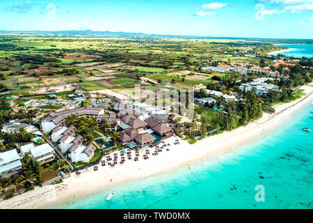 Aerial drone view at luxury resorts and coastline at Belle Mare beach on island Mauritius. Toned image. Stock Photo