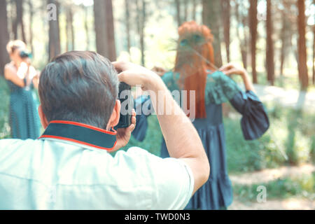 group of student photographers taking pictures at photography shooting workshop course outdoors Stock Photo