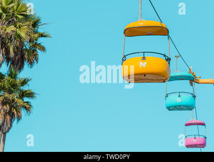 Three colorful cable cars against a clear blue sky. Stock Photo