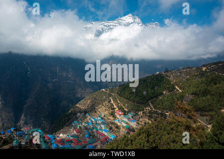 Key town of Namche Bazaar in Nepal Himalayas with majestic Kongde Ri peak in background Stock Photo