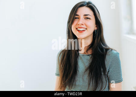 young confident brunette woman smiling Stock Photo