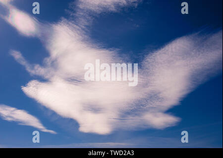 Cirrocumulus clouds in blue sky with abstract shapes and the appearance of motion Stock Photo