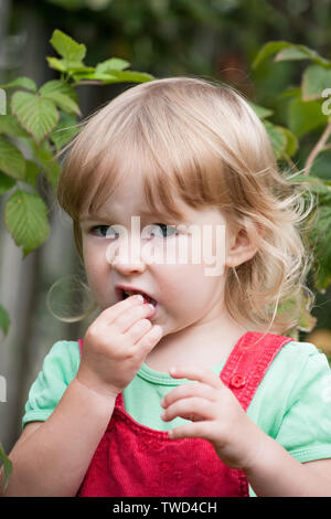 View into children mouth with white blue braces with central screw for  exact setting Stock Photo - Alamy