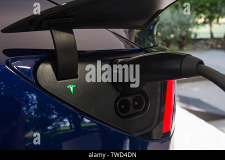 Detail of charging plug of Tesla Model 3. 2019 edition of Parco Valentino car show hosts cars by many brands and car designers in Valentino Park in Torino, Italy. Stock Photo